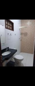 a bathroom with a toilet and a sink and a shower at RR Deck Betolandia in Juazeiro do Norte