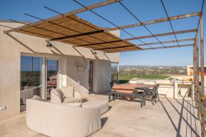 a patio with white furniture and a table and chairs at Tenuta le Menadi in Noto +39 photos