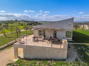 a house with a deck with a view at Tenuta le Menadi in Noto
