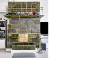 a kitchen with a brick fireplace with vases on it at Charming Villa Apartment in Kauniainen