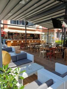 a patio with couches and tables and chairs at Admiral Plaza 35 -studio-Sunny Beach in Sunny Beach +25 photos