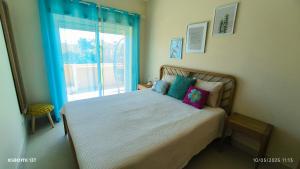 um quarto com uma cama grande com janela em Sunshine Apartment em Tavira mais 22 fotografias