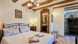 a bedroom with a bed with two towels on it at Olimpia 3 in Novigrad Istria +28 photos