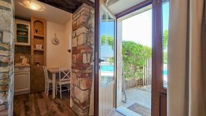 a kitchen with a sliding glass door leading to a patio at Olimpia 3 in Novigrad Istria