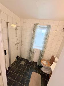 a bathroom with a toilet and a window at Cozy apartment close to nature in Tromsø +16 photos