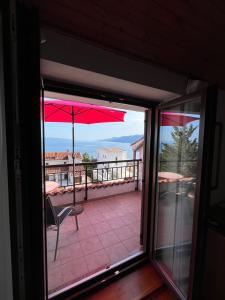 a view of a balcony with an open glass door at View point rooms in Matulji +5 photos