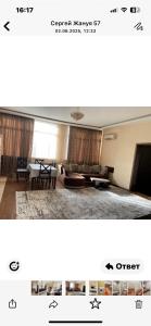 a living room with a couch and a table at Жануя in Zhezdi