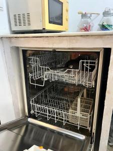 a black dog laying inside of an oven at Appartements meublés BELLES & BEAU à Yaoundé Ngousso in Yaoundé