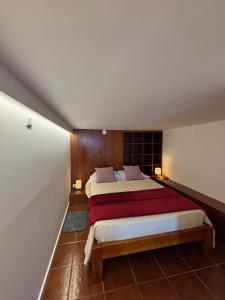 a bedroom with a large bed with a red blanket at Atlantic - Sea Front in Oia +13 photos