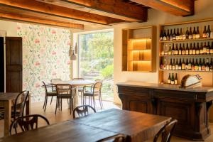 a dining room with tables and chairs and a window at Tenuta Saiano Resort in Torriana