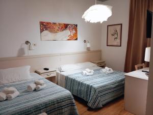 Postel nebo postele na pokoji v ubytování Hotel Ariston