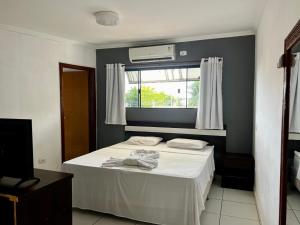 Postel nebo postele na pokoji v ubytování Oasis Praia Hotel