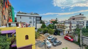 a view of a city with cars parked in a parking lot at Peaceful Studio With Kitchen & Terrace 301 in Patna