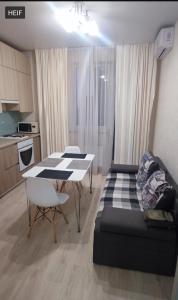 a living room with a table and a couch at 51 жемчужина Аркадія in Odesa +5 photos