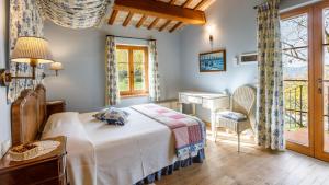 a bedroom with a bed and a desk and a piano at La Tana del Ghiro 18, Emma Villas in Ravenna +37 photos