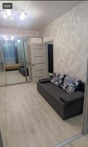 a bedroom with a bed and a large mirror at 51 жемчужина Аркадія in Odesa
