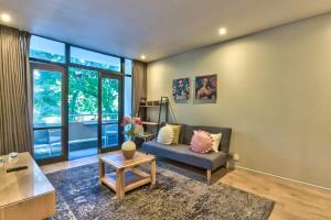 a living room with a couch and a table at St Martini Gardens Studio in Cape Town +14 photos
