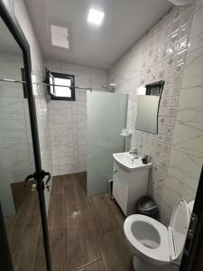 a bathroom with a toilet and a sink at Еко Къщи Къмпинг Созопол Еко in Sozopol +54 photos