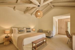 A bed or beds in a room at Nikki Beach Resort & Spa Porto Heli