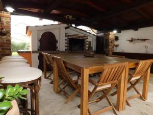a wooden table and chairs in a living room at Del Mar Rab in Kampor