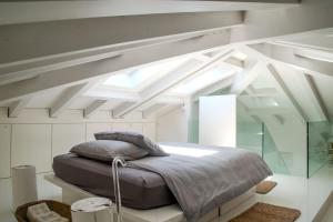 une chambre avec un grand lit dans une pièce blanche dans l'établissement Villa Rosa Del Mare, à Senigallia