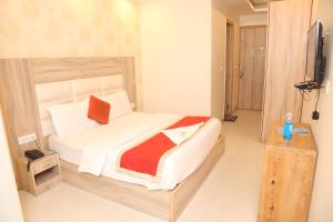 Postel nebo postele na pokoji v ubytování Hotel Aman Inn