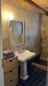 a bathroom with a sink and a mirror at Eternia Suites in Katakoúli +98 photos