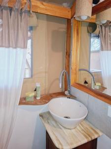a bathroom with a white sink and a window at Tenda Familiare in Monterotondo