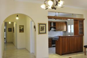 a kitchen with an archway leading to a dining room at Seaside Villa in Korinthos