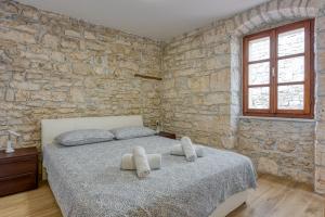 Ένα ή περισσότερα κρεβάτια σε δωμάτιο στο Holiday House Vili