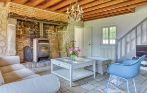 a living room with a couch and a fireplace at Athentique Maison Normande in Vénesville