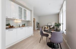 a kitchen and dining room with a table and chairs at Attractive and central apartment in Ålesund