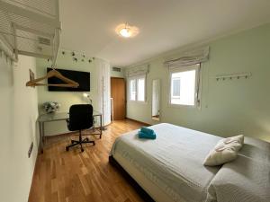 a bedroom with a bed and a desk and a chair at Rooms Aribau 133 in Barcelona