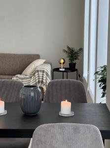 a living room with a table with two candles on it at Attractive and central apartment in Ålesund +27 photos