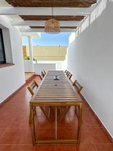 a wooden table and chairs in a room at Surf and Stay House in Corralejo