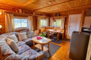 a living room with a couch and a table at Ferienhaus Gustl in Bischofsreut
