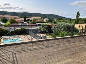 a balcony with a wooden deck with a fence at Villa la Gardiole in Vic-la-Gardiole