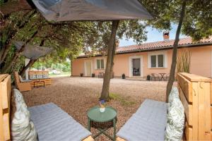 a patio with two chairs and a table and an umbrella at Apartman Babich in Rovinj