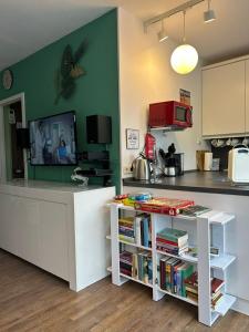 a kitchen with a counter with a shelf of books at App 624 Panoramic Hohegeiß Terrassenhaus in Braunlage