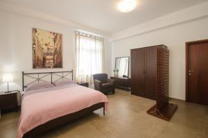 a bedroom with a bed and a chair and a cabinet at Luxury Istrian Apartment ZP in Marčana