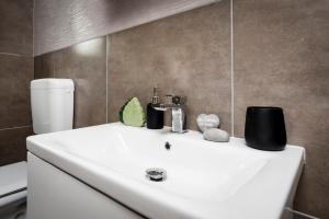 a bathroom with a white sink and a toilet at Apartman Babich in Rovinj +40 photos