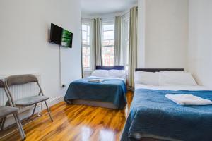 Postel nebo postele na pokoji v ubytování Harriet Gardden Hotel