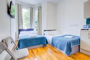 Postel nebo postele na pokoji v ubytování Harriet Gardden Hotel