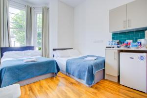 Postel nebo postele na pokoji v ubytování Harriet Gardden Hotel