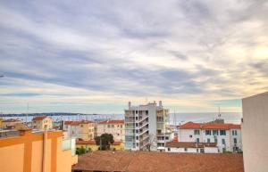 a view of a city under a cloudy sky at Le Clair Golfe-Juan - T2 terrasse vue mer Parking privé WIFI - LIMESTAY in Golfe-Juan +5 photos