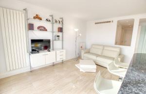 a white living room with a couch and a table at Le Clair Golfe-Juan - T2 terrasse vue mer Parking privé WIFI - LIMESTAY in Golfe-Juan