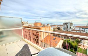 a balcony with a view of a city at Le Clair Golfe-Juan - T2 terrasse vue mer Parking privé WIFI - LIMESTAY in Golfe-Juan