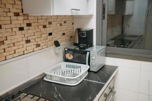 a microwave sitting on a counter in a kitchen at TERANGA IMMO LUXE in Dakar +170 photos