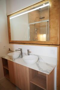 a bathroom with two sinks and a large mirror at La verrière in Avignon +12 photos