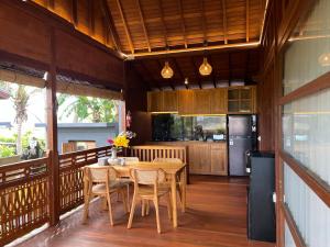 a kitchen with a table and chairs on a balcony at Villa Gong bali in Ubud